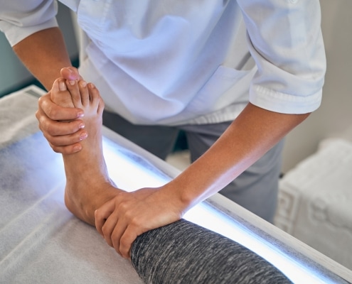Close up of medical worker massaging foot