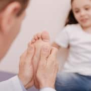 Capable trained rheumatologist treating patients feet