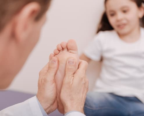 Capable trained rheumatologist treating patients feet